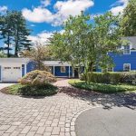 Grand Colonial home with vibrant blue exterior, nestled in the picturesque Farmington Village at 5 Church Street, Farmington, CT.