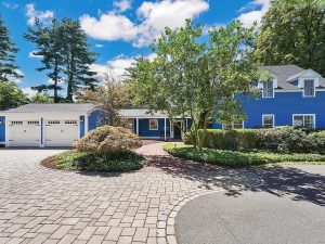 Grand Colonial home with vibrant blue exterior, nestled in the picturesque Farmington Village at 5 Church Street, Farmington, CT.