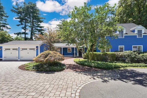 Grand Colonial home with vibrant blue exterior, nestled in the picturesque Farmington Village at 5 Church Street, Farmington, CT.