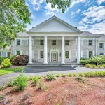 Stately brick mansion with grand columns and lush landscaping at 1 John Steele Rd, Farmington, CT