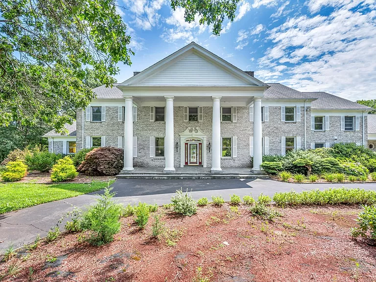 Stately brick mansion with grand columns and lush landscaping at 1 John Steele Rd, Farmington, CT