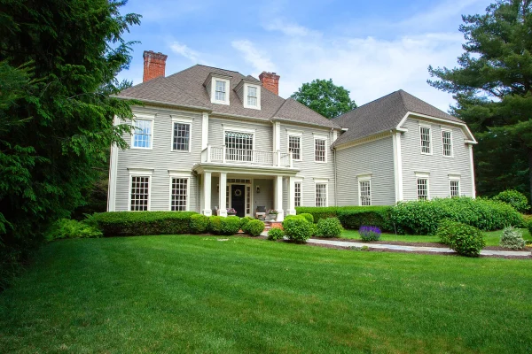 Front exterior view of the luxurious colonial-style home at 7 Wentworth Park, Farmington, CT 06032, featuring a manicured lawn, professional landscaping, and a grand entrance.