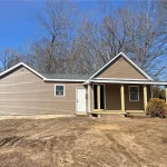 A small, unfinished single-family home at 196 Brickyard Rd, Farmington, CT, with beige siding, no landscaping, and missing doors and windows, sitting on a barren dirt lot.