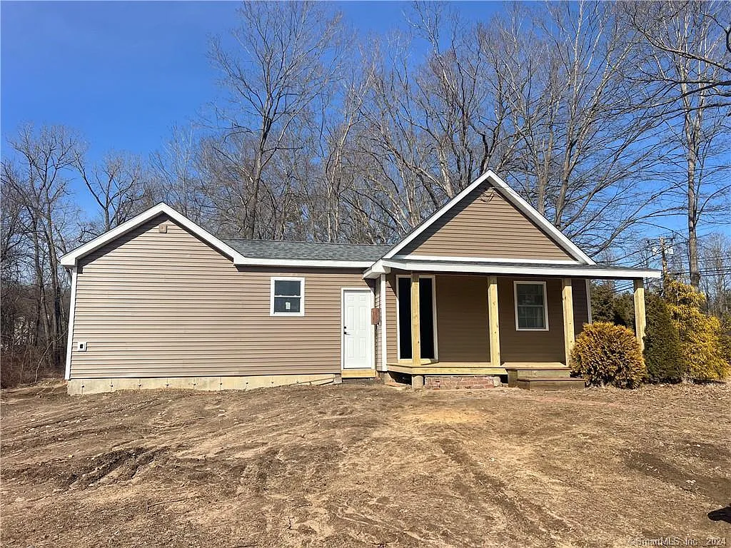 A small, unfinished single-family home at 196 Brickyard Rd, Farmington, CT, with beige siding, no landscaping, and missing doors and windows, sitting on a barren dirt lot.