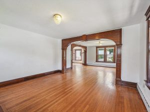 1920s bungalow at 1690 Farmington Avenue, Unionville, CT, featuring a charming front porch with unique stonework and lush greenery.